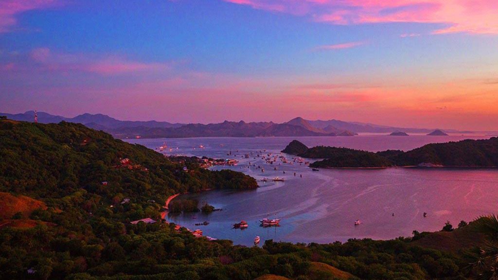 people enjoying sunset view from bukit cinta overlooking labuan bajo