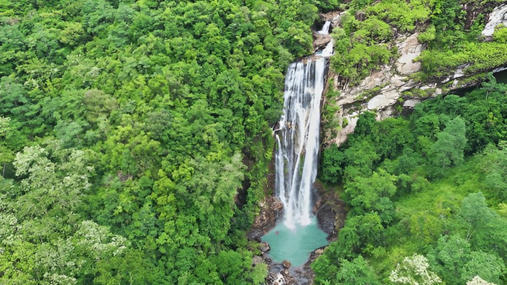 Aerial view of Cunca Rami Waterfall in West Manggarai Flores Indonesia surrounded by dense green forest