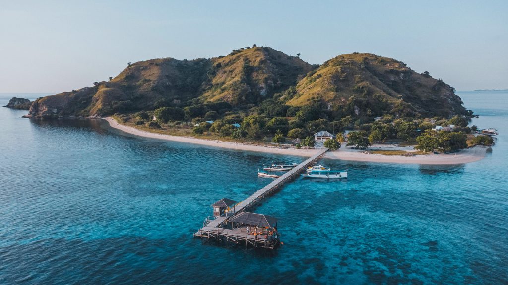 Kanawa Island location near Labuan Bajo with wooden pier and turquoise water in Flores Indonesia