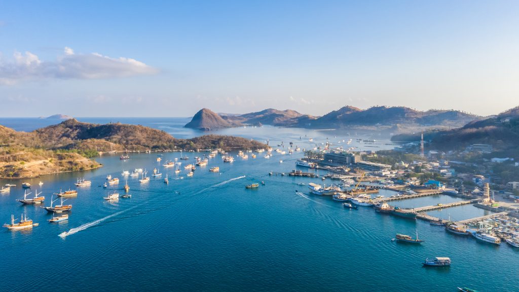 labuan bajo town and harbor in flores indonesia with boats and surrounding hills