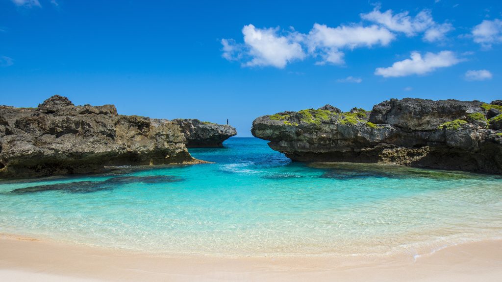 hidden turquoise cove surrounded by cliffs at mandorak beach sumba island