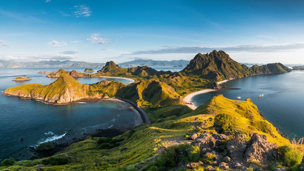 sunrise light over padar island highlighting hills and bays during golden hour