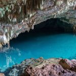 rangko cave labuan bajo with crystal clear underground lake and limestone formations