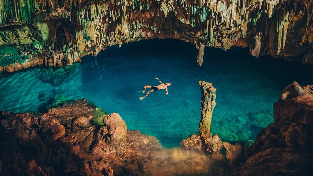 interior of a limestone cave with turquoise water near labuan bajo flores indonesia