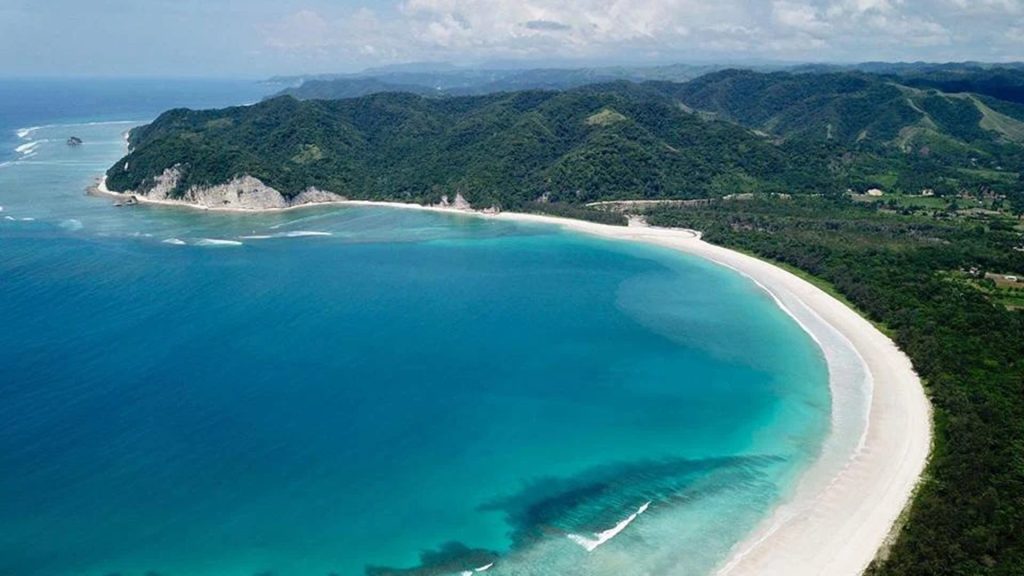 surfer riding powerful waves at tarimbang beach east sumba