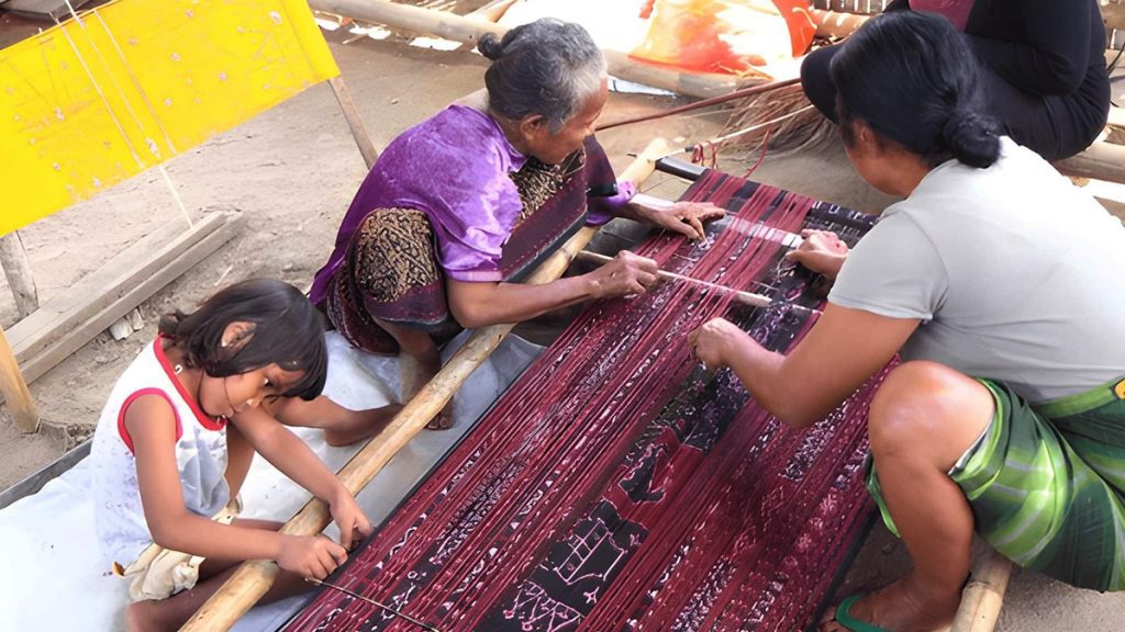 local women weaving traditional ikat fabric in Moni Village Flores Indonesia